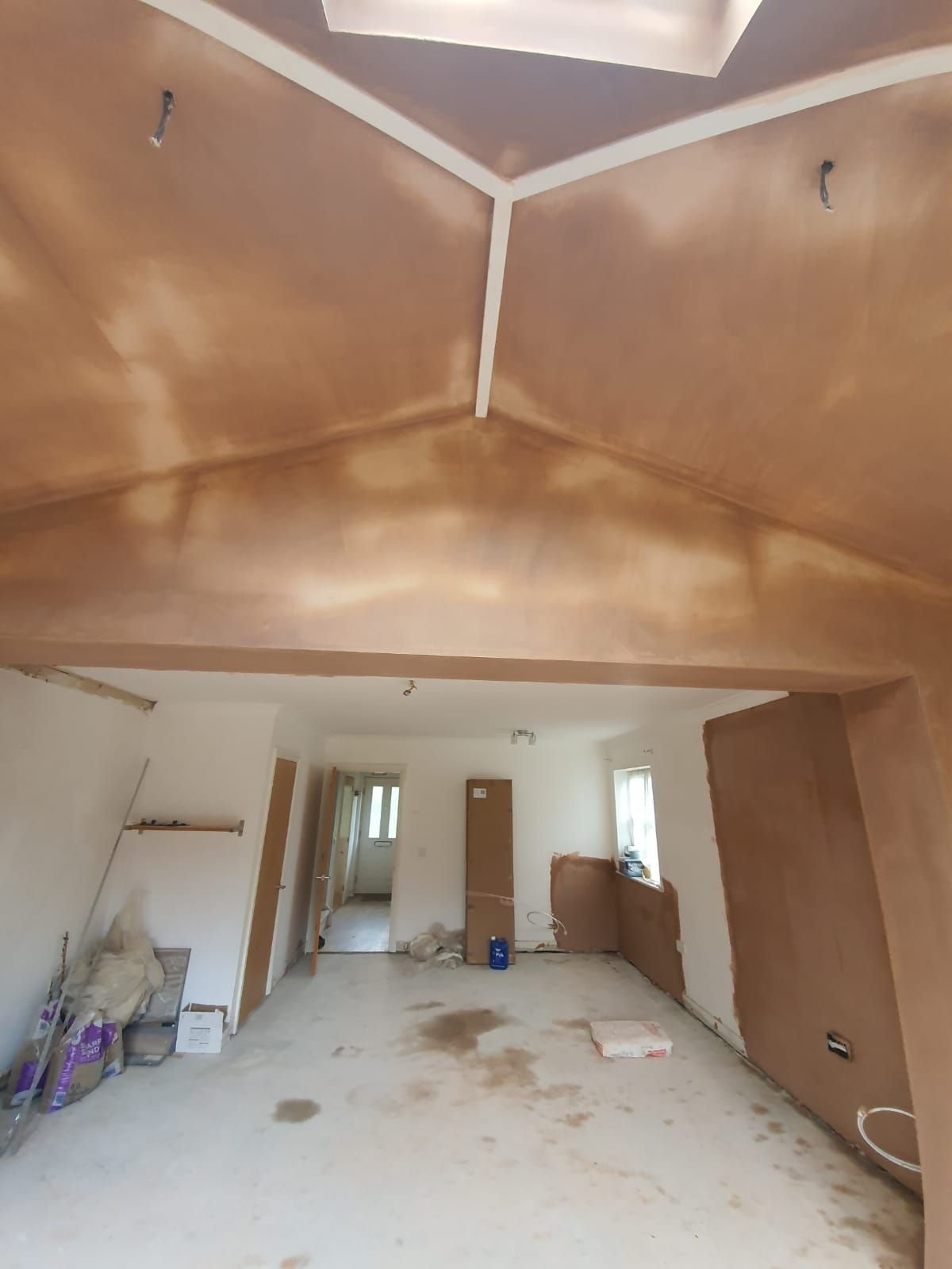 Interior construction site with drywall and exposed ceiling
