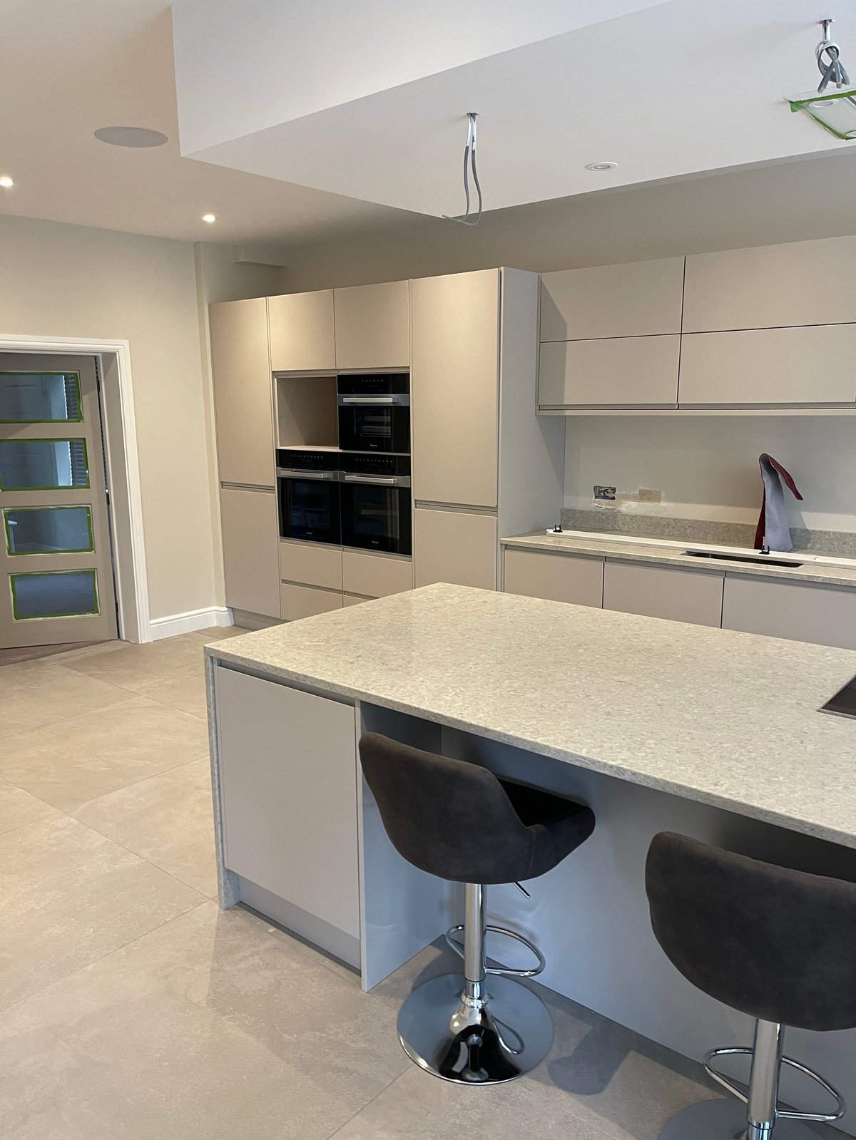 Modern utility room with island and bar seating